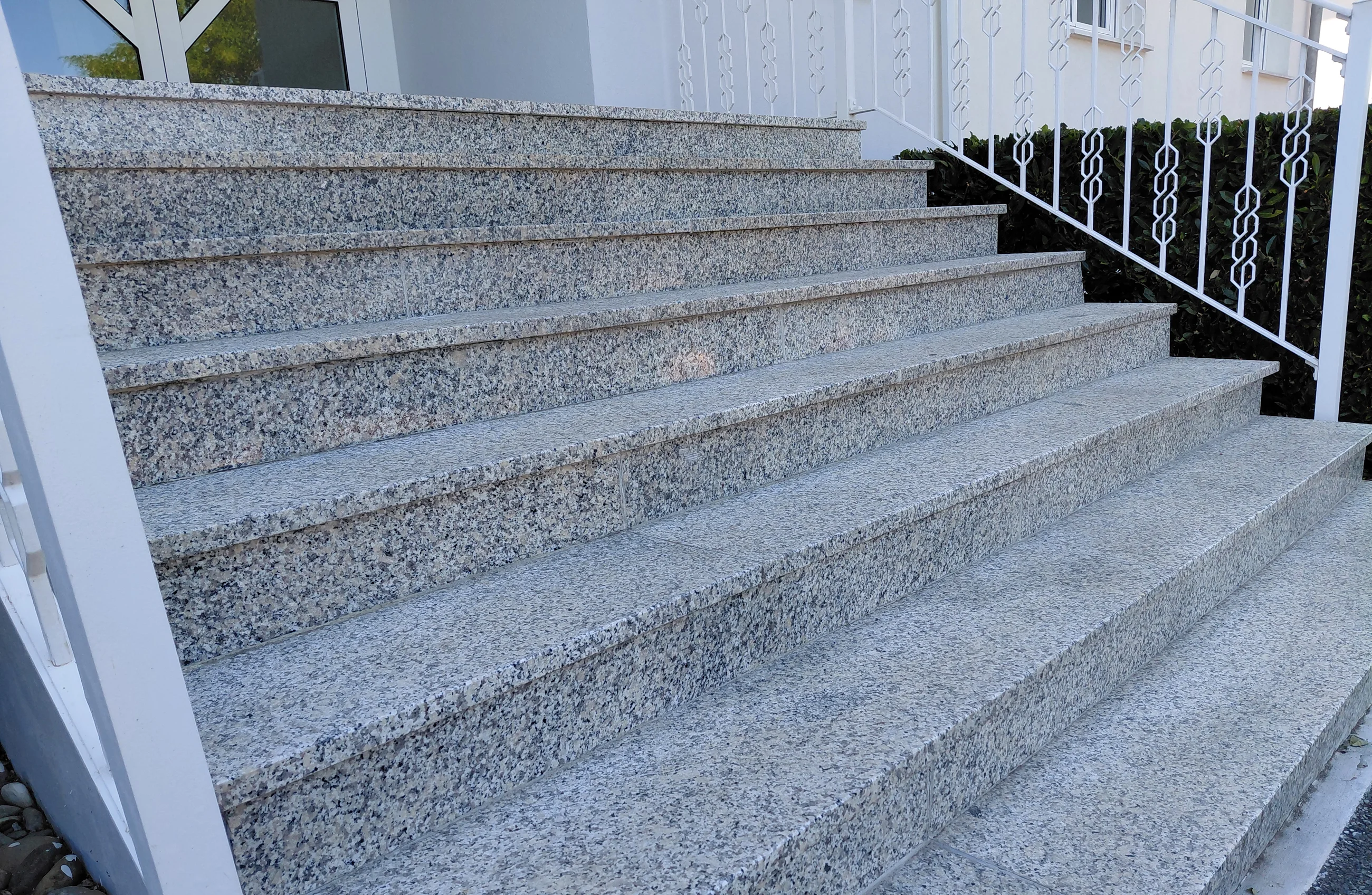 Detailansicht einer Außentreppe mit Natursteinplatten und sauberem Fugenbild